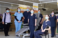 Group of cancer care clinicans standing with social distancing and face masks